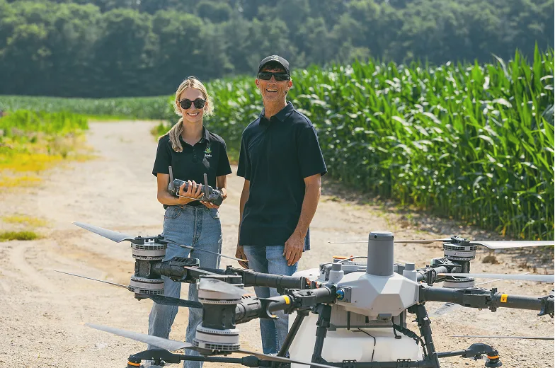 Sylvite agronomists standing with an agricultural drone on a farm lane