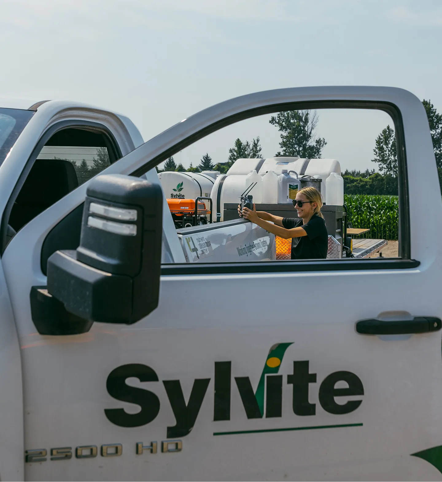 Sylvite team member taking a photo from a Sylvite truck at a field site